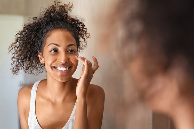 Smiling women looking at reflection